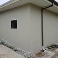 Rendered granny flat exterior with clean modern finish on a Sydney block