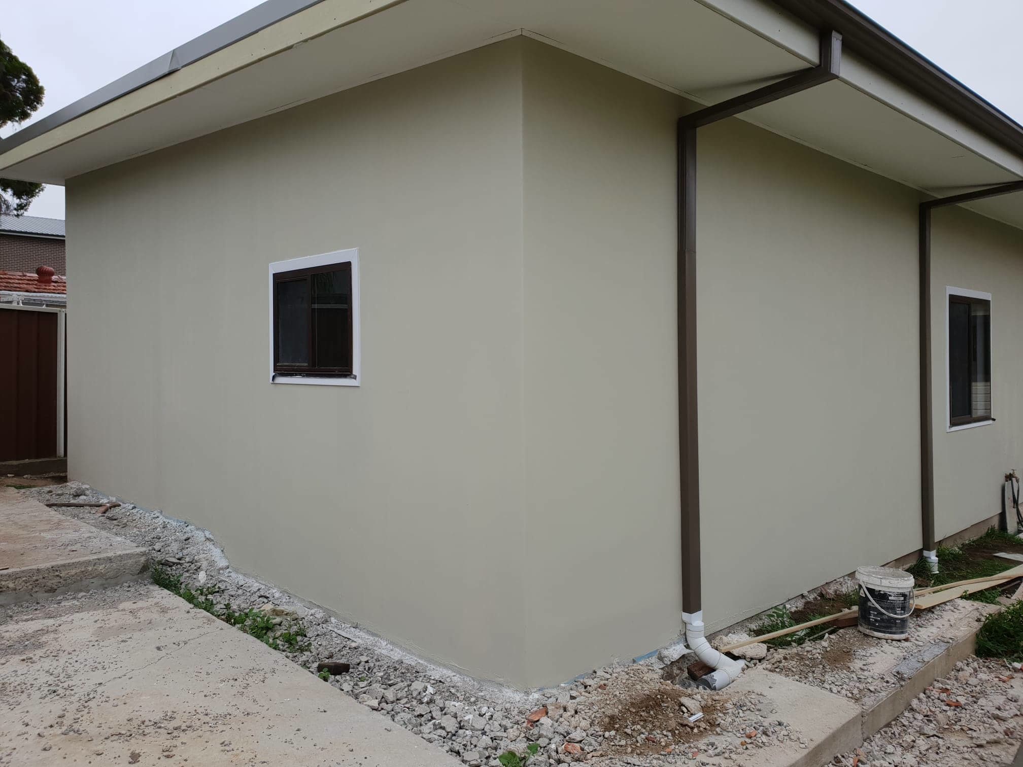 Rendered granny flat exterior with clean modern finish on a Sydney block